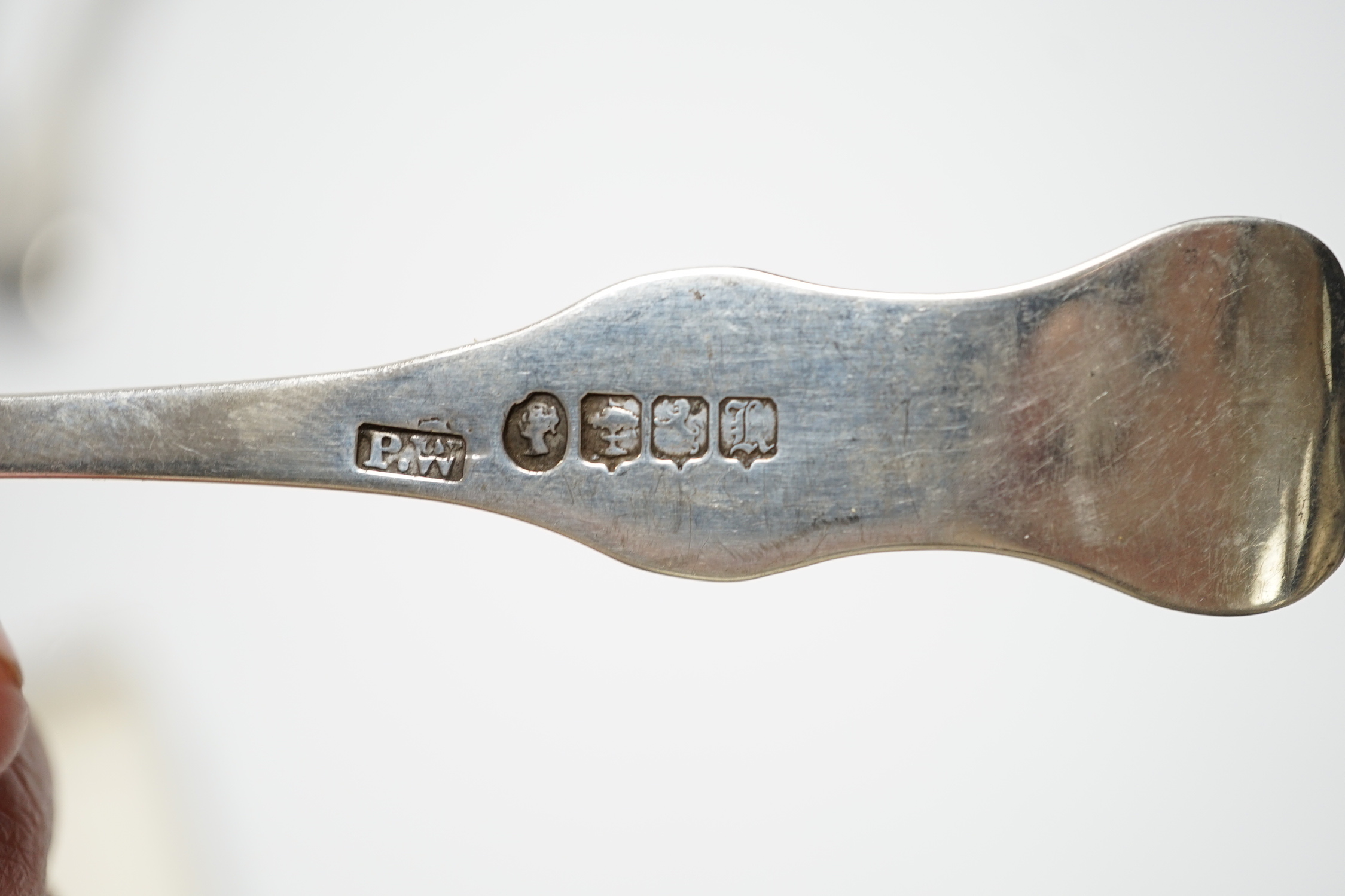 A William IV silver fiddle pattern sauce ladle, London, 1831 and six other assorted silver spoons.